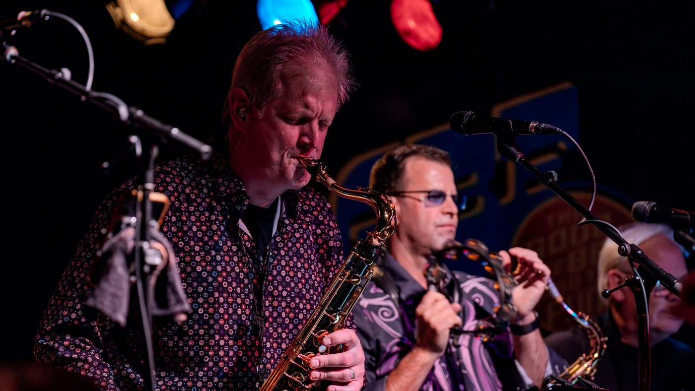 The horn section performing live